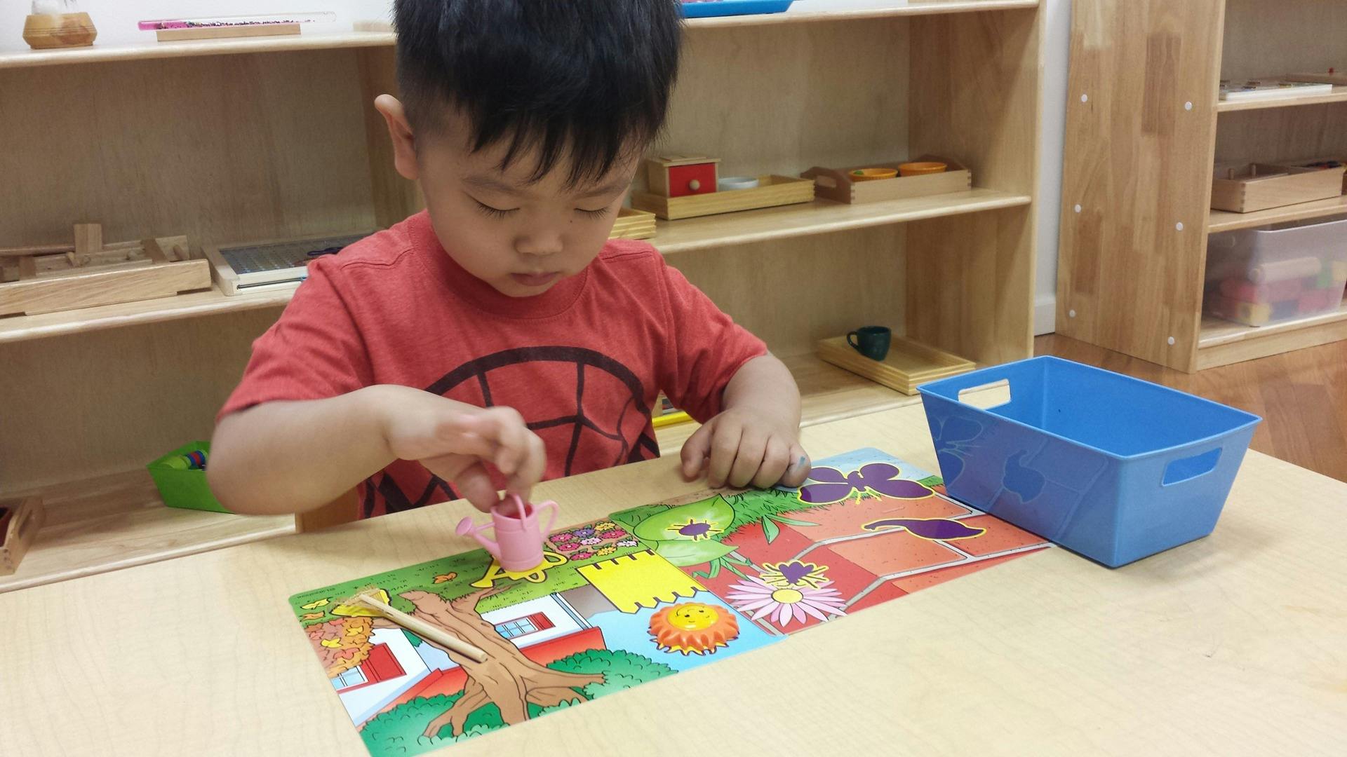 Child playing with a puzzle on a table