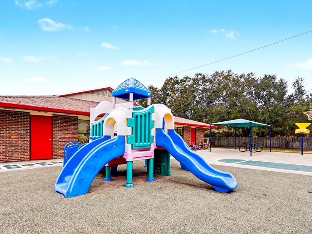 Colorful outdoor playground with slides and swings on a sunny day