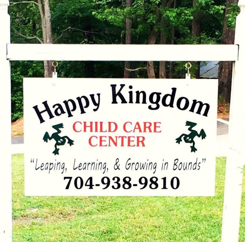 Happy Kingdom Child Care Center sign with frog illustrations