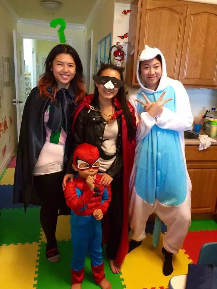 Three people and one child in costumes posing for a photo