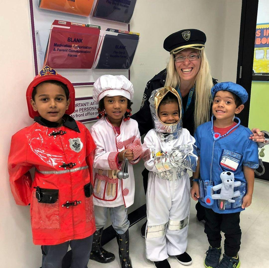 Adult and four children in career costumes
