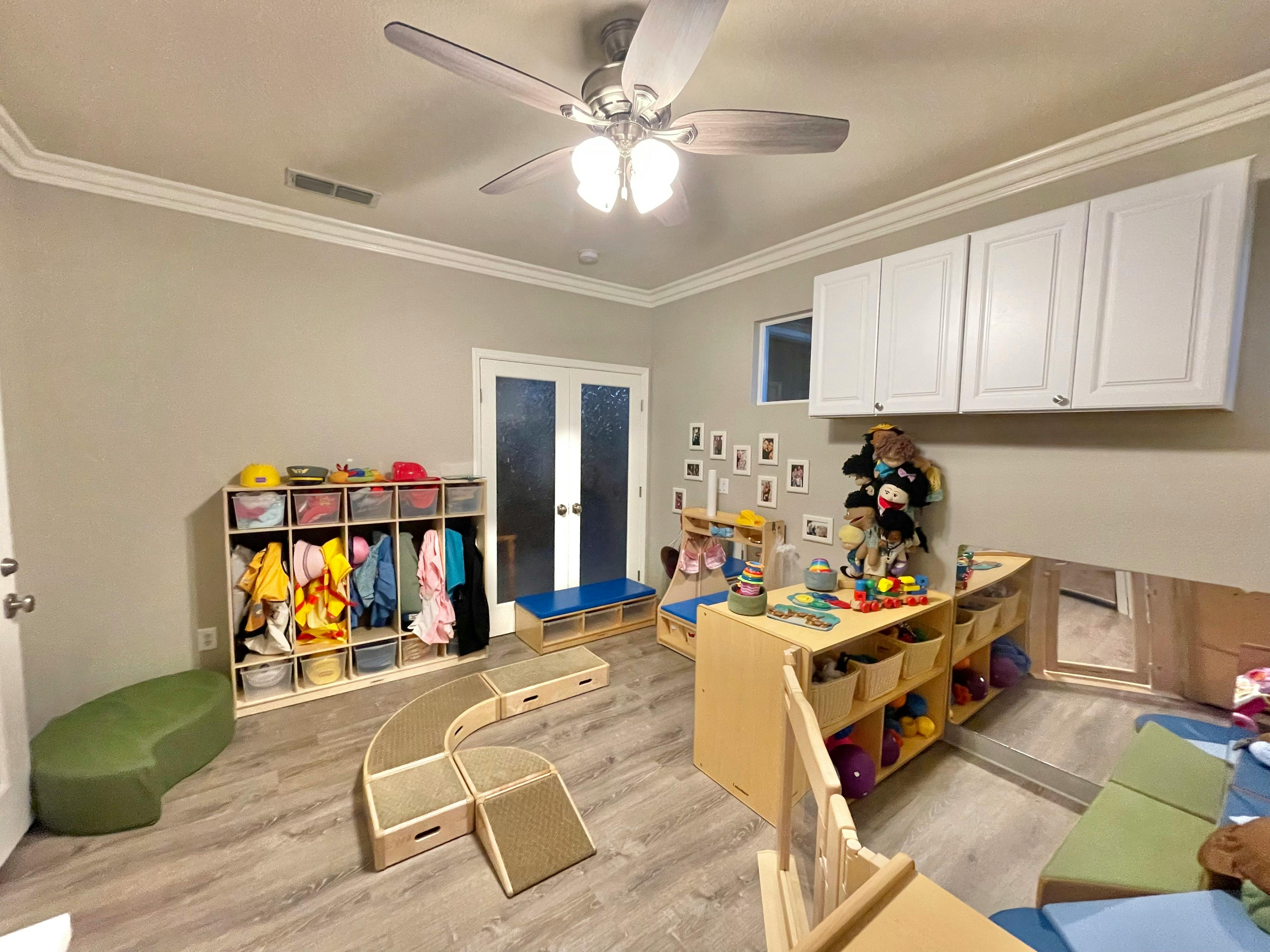 Playroom with cubbies, toys, and small furniture