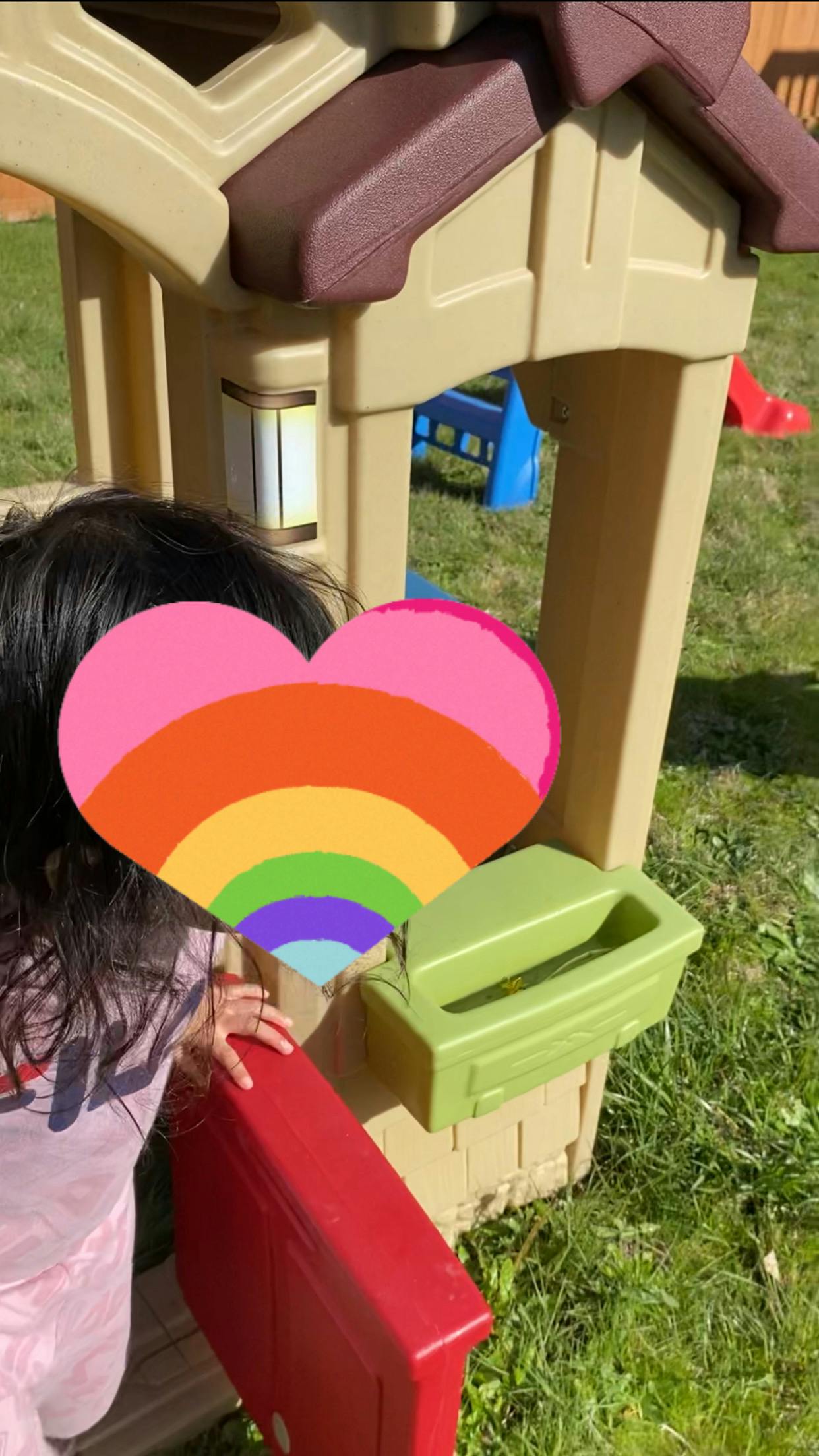 Child playing with a toy house
