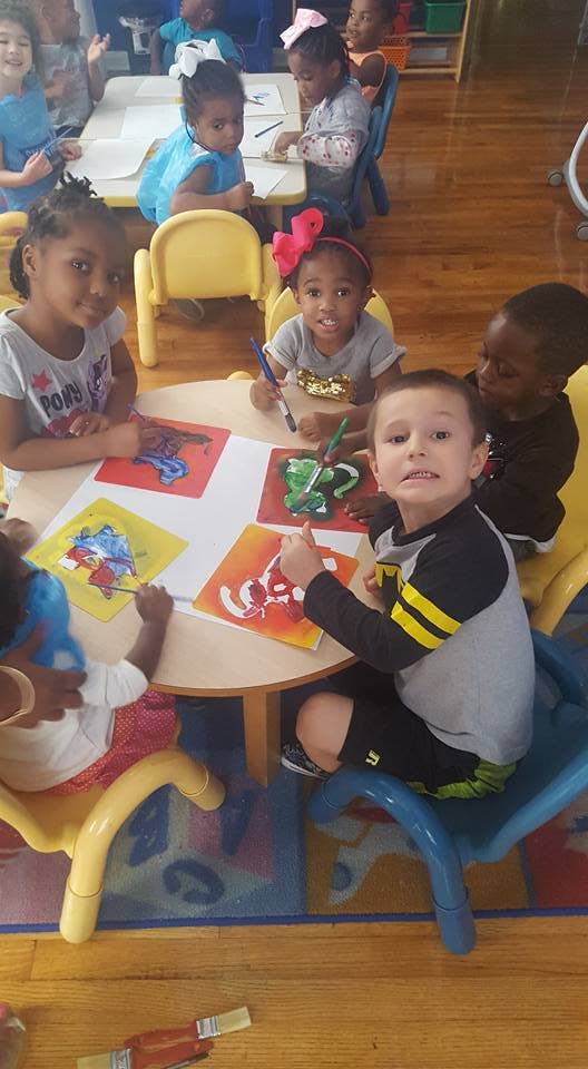 Children painting at a table