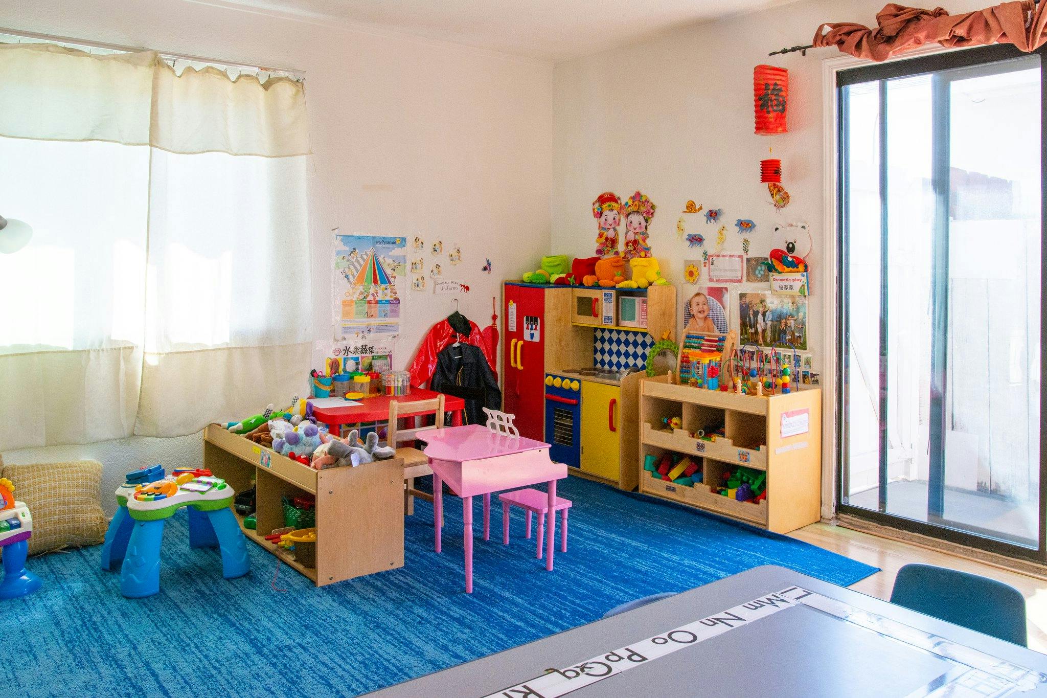Playroom with colorful toys, small tables, and storage shelves
