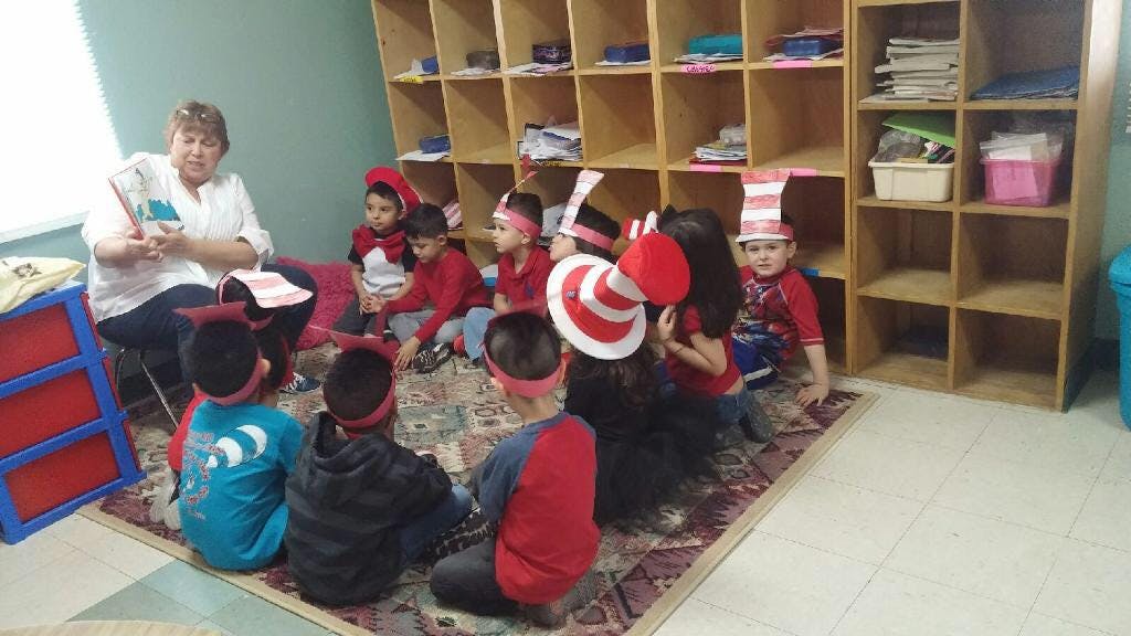 Person reading to children in a classroom