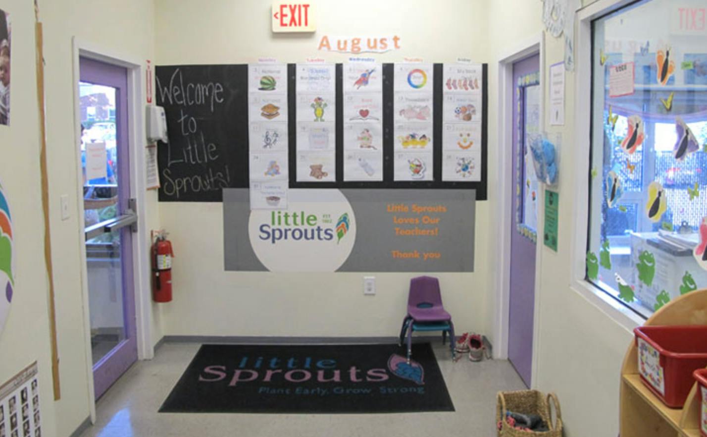 Entryway with a welcome sign, bulletin board, and floor mat