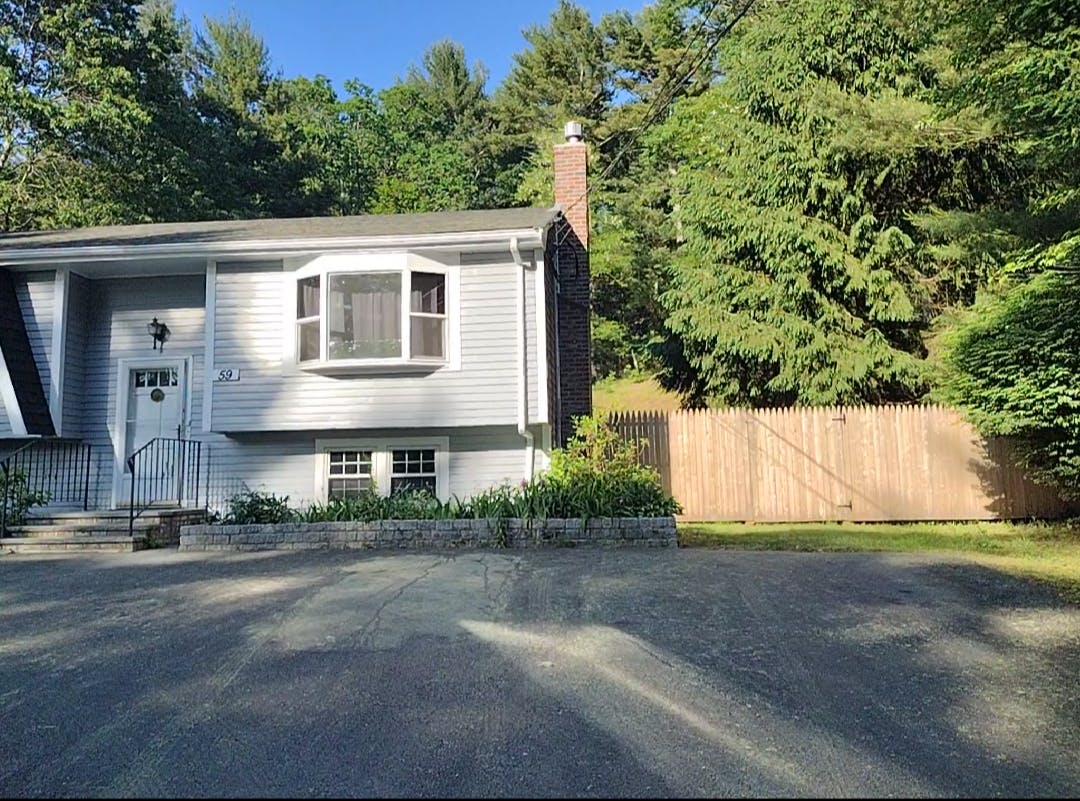 House with light gray siding and a bay window