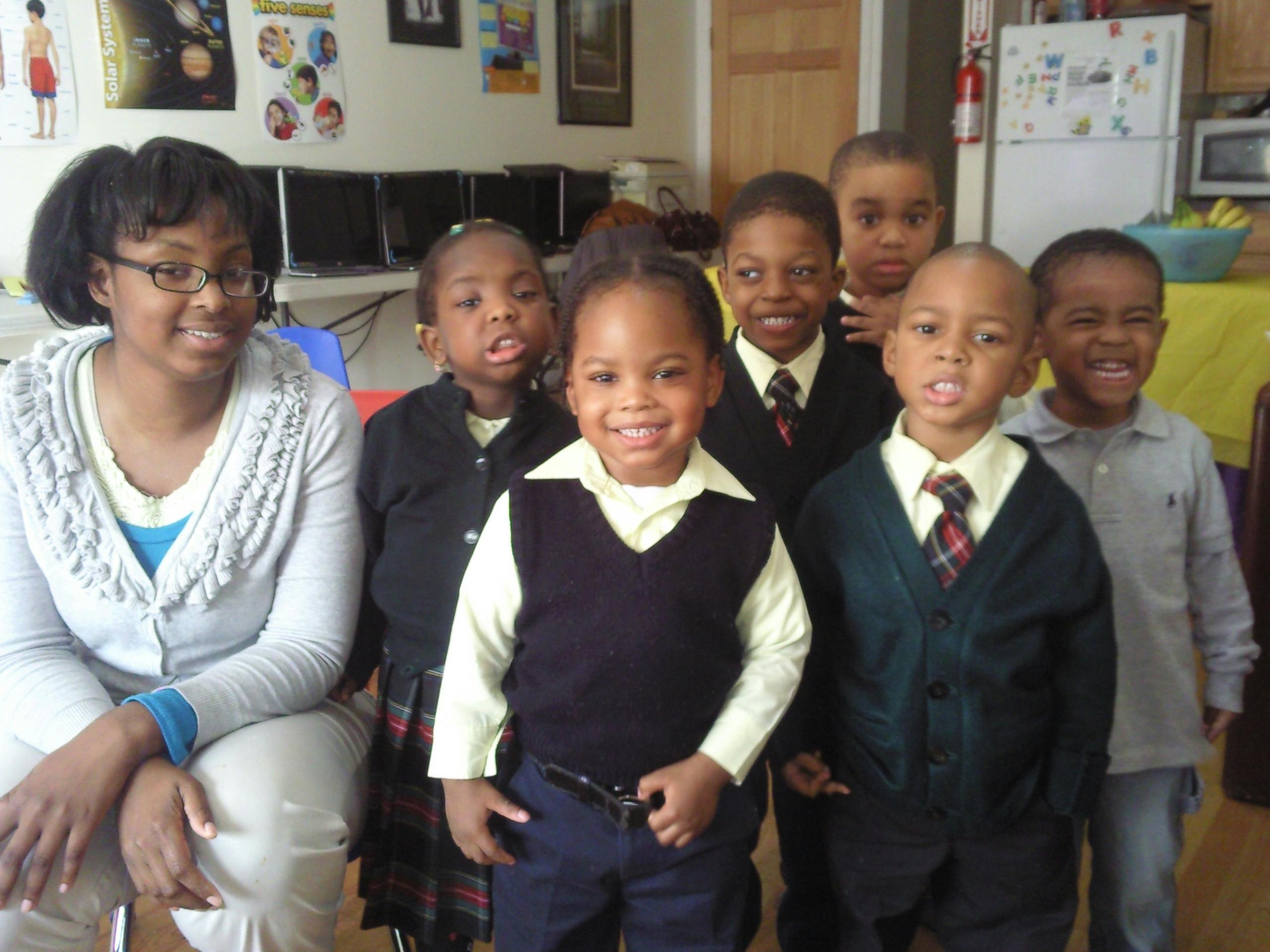Adult and group of children posing for a photo
