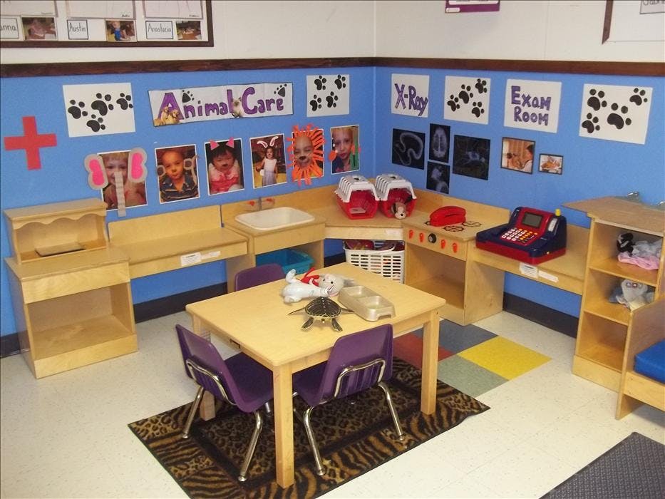 A classroom with an animal care theme, with a small table and chairs in the center