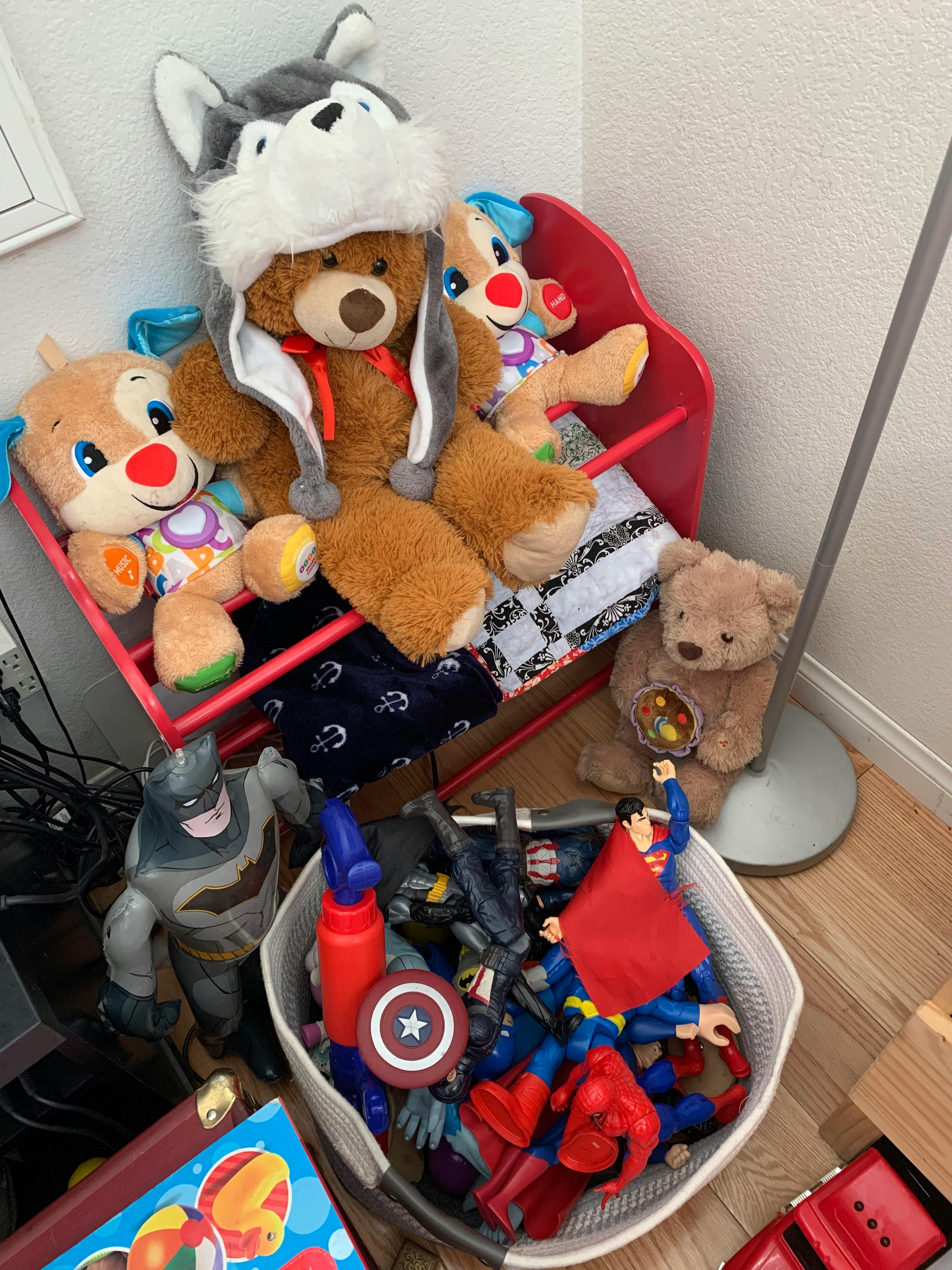 Stuffed animals and action figures in a room