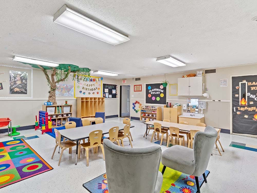 Colorful classroom with small tables and chairs