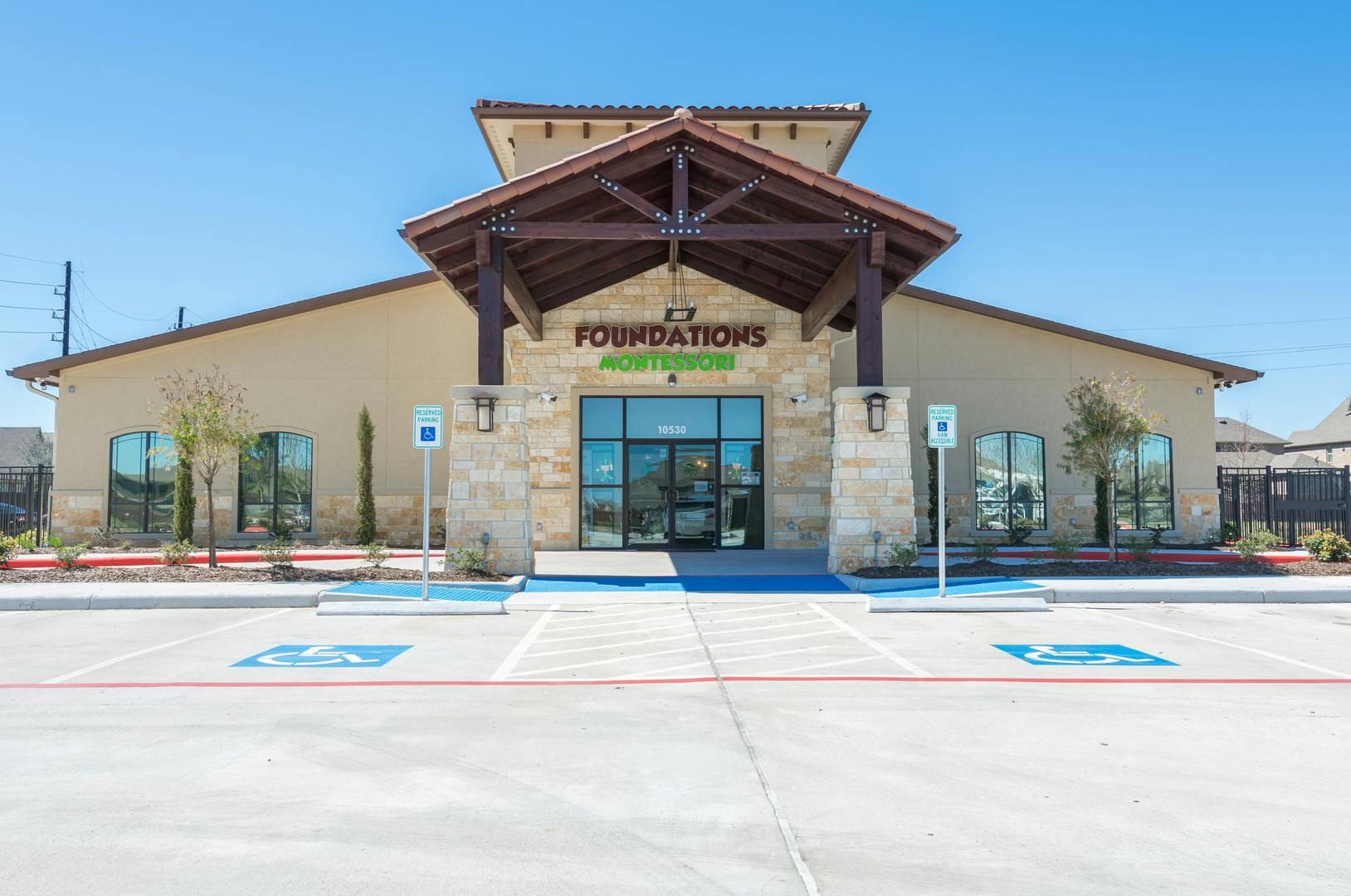 Building with "Foundations Montessori" sign and parking lot with handicap spaces