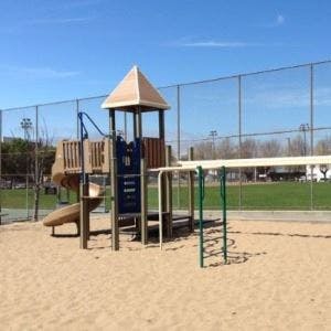 Playground with a slide, climbing structure, and monkey bars