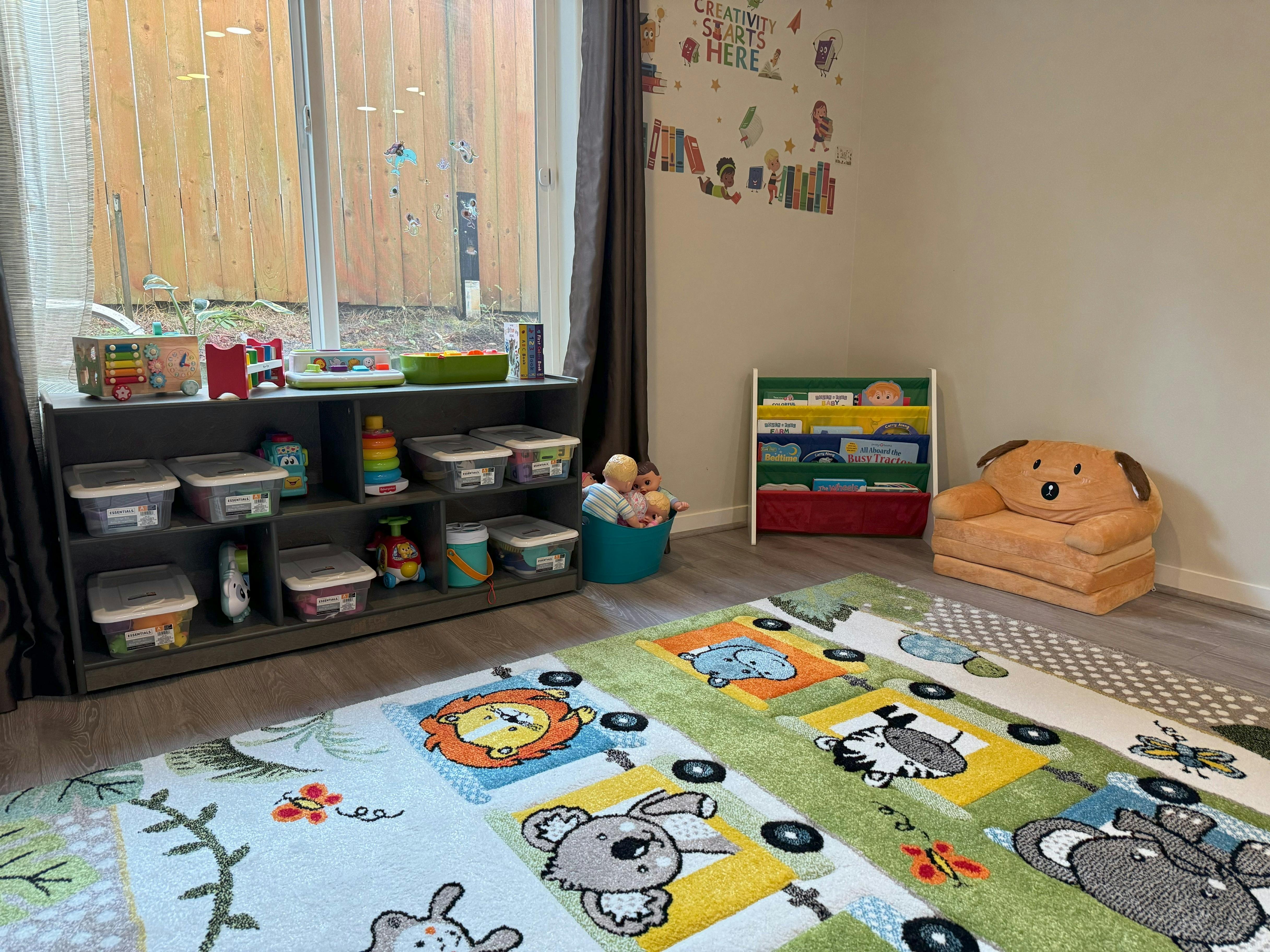 Children's playroom with a colorful rug, toy storage, and a small chair