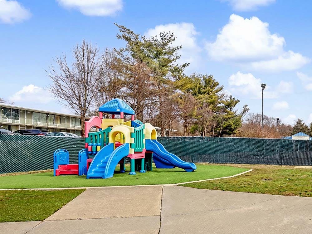 Colorful playground structure with slides on artificial turf