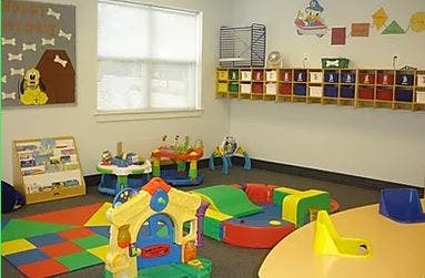 Playroom with colorful toys and play mats