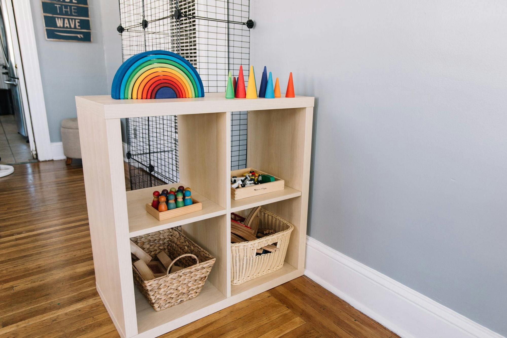 Wooden cube shelf with colorful toys and baskets