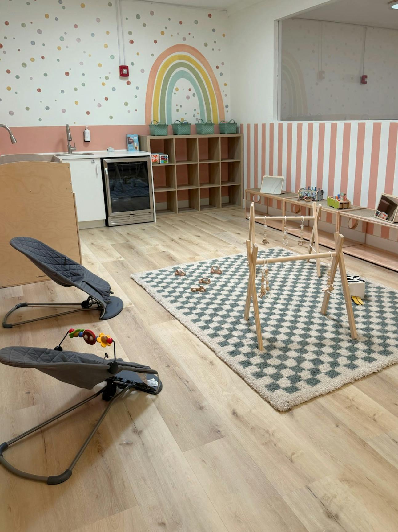 baby and toddler play room with a rainbow wall