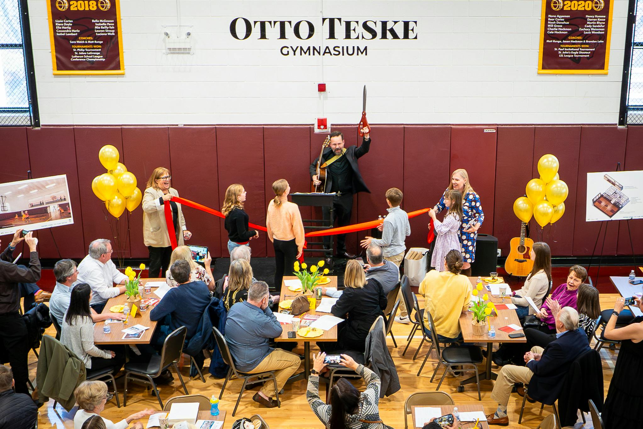 Magician performing for an audience in a gymnasium
