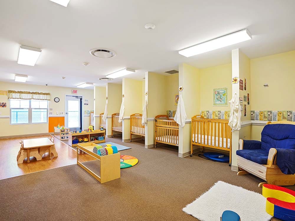 Cribs and small furniture in a child care room