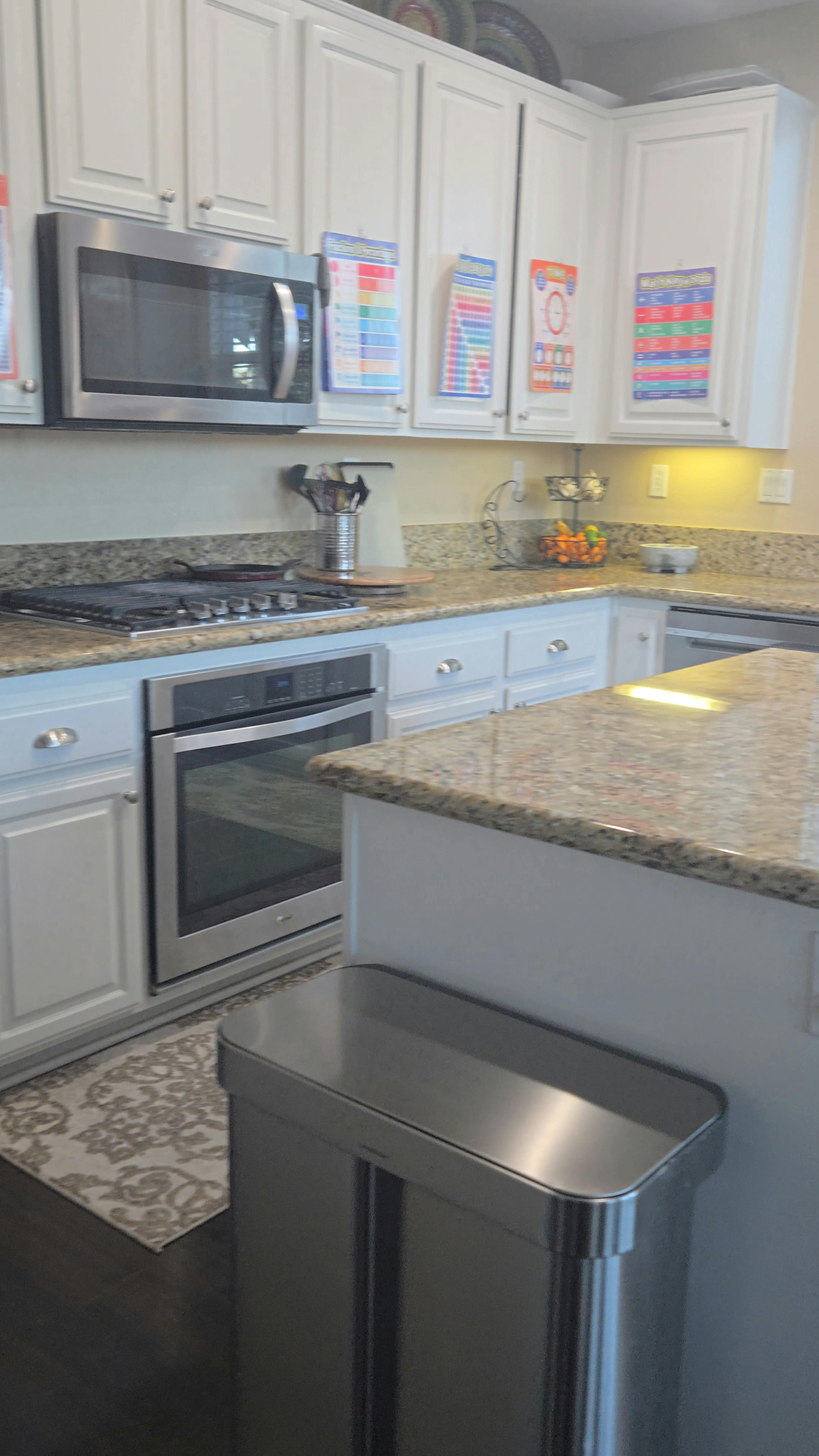 Kitchen with white cabinets, stainless steel appliances, and granite countertops