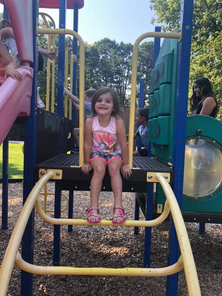 Child sitting on a playground structure