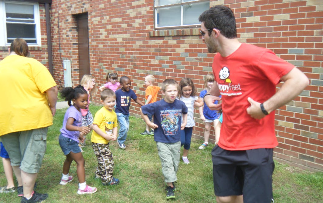 Adults supervising children playing outdoors