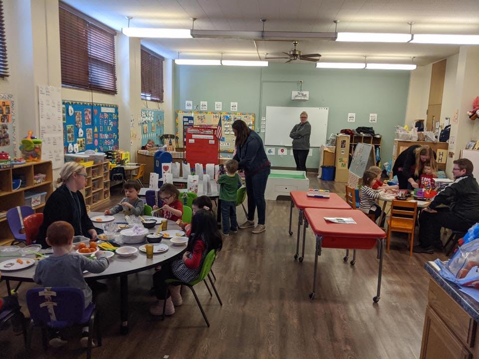 Adults and children in a classroom