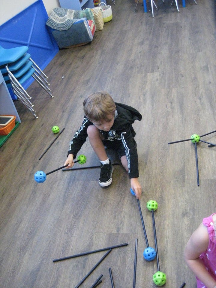Child playing with construction toys on the floor