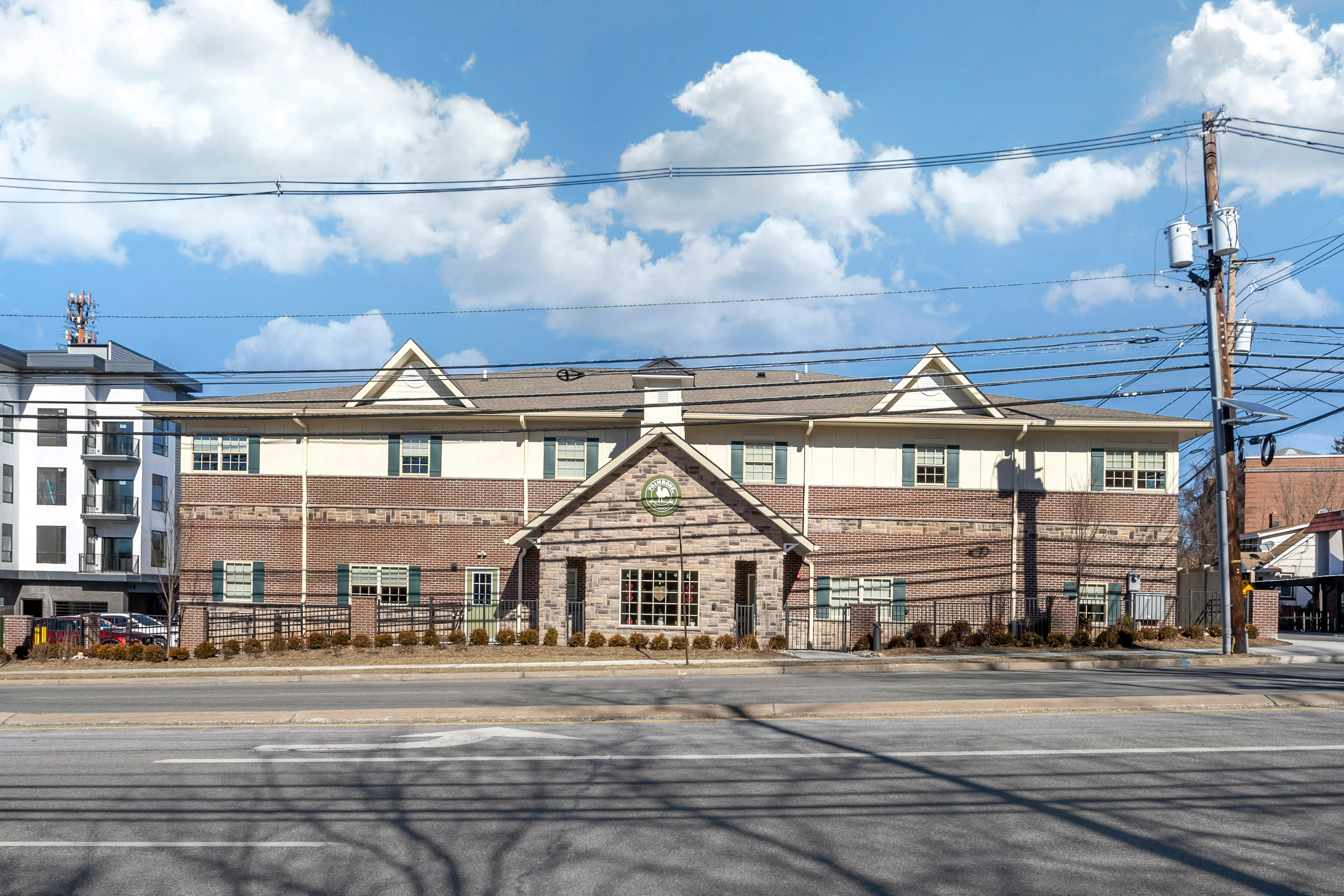 A brick and tan building with a sign that reads "Primrose School"
