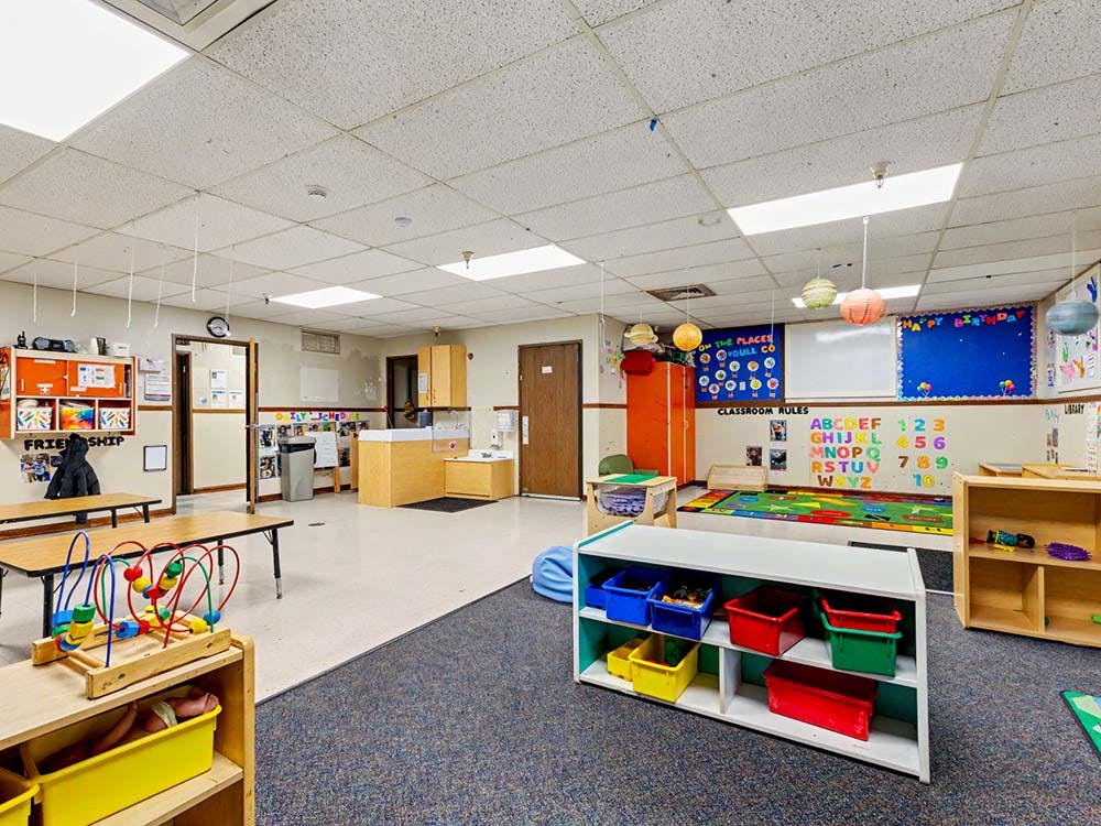 Classroom with tables, shelves, alphabet and numbers on a wall