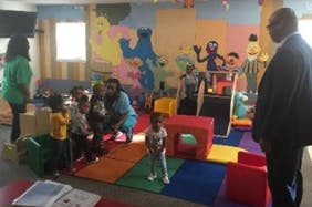 Adults and children in a colorful play area