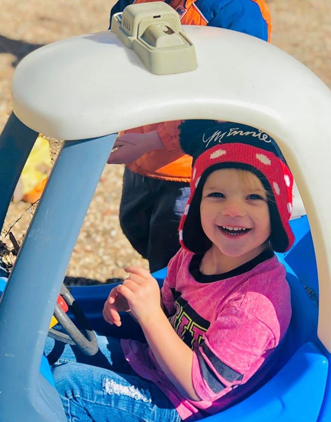 Child in a toy car
