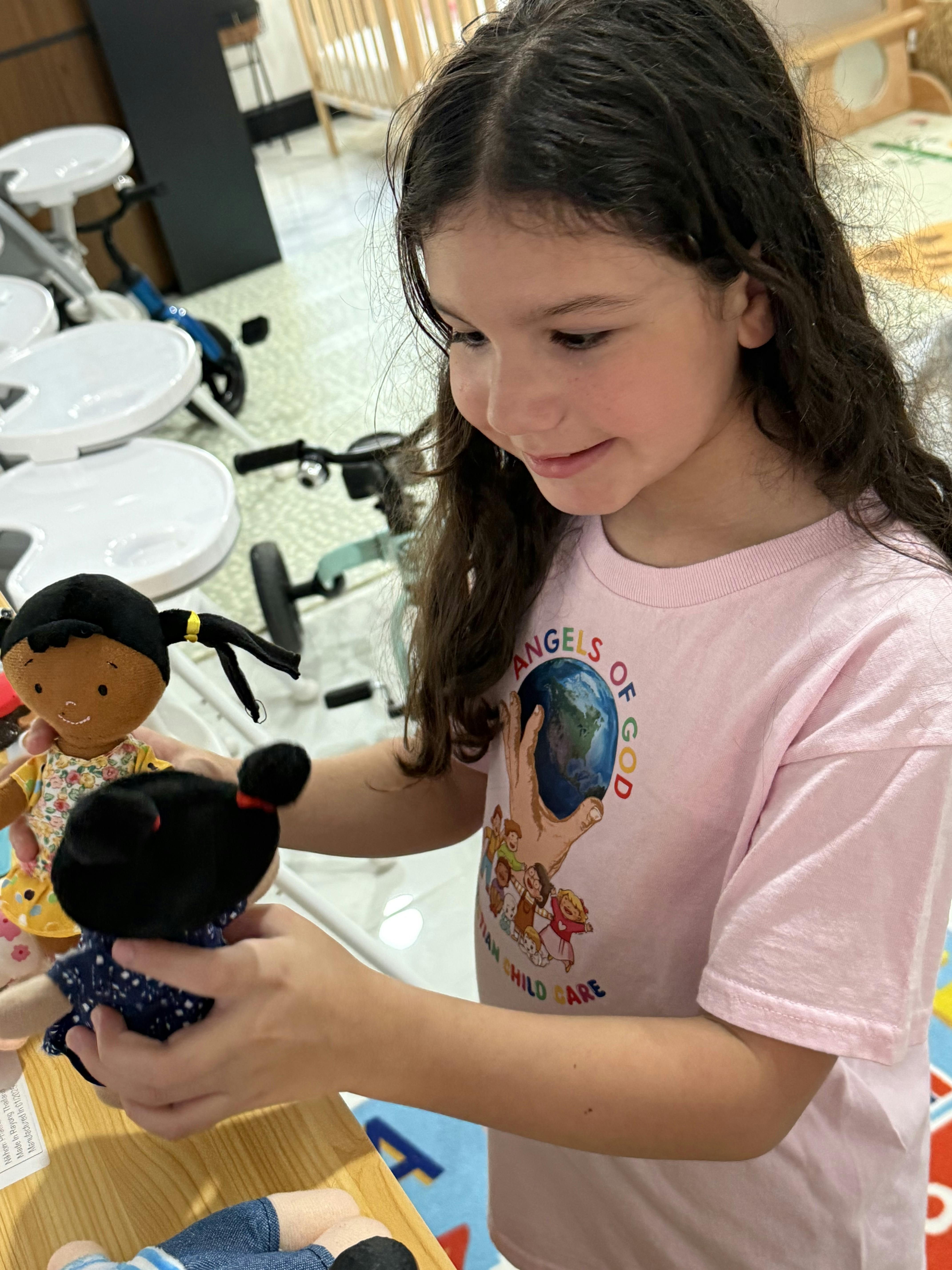 Child playing with plush dolls