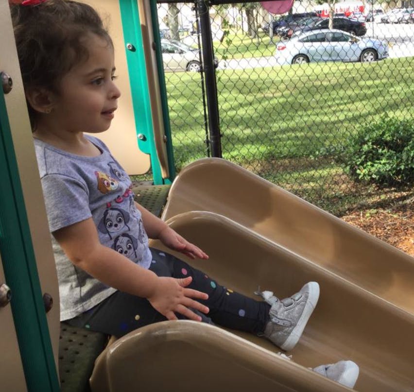 Child sitting on a playground slide