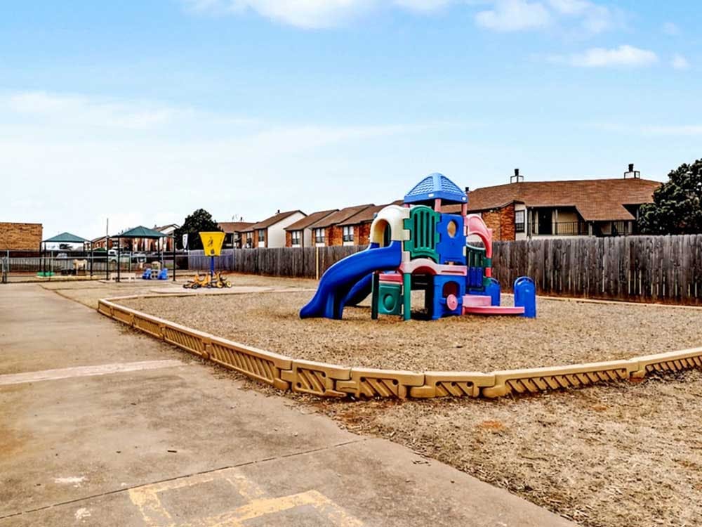 Playground with colorful play structure, slides, and swing sets
