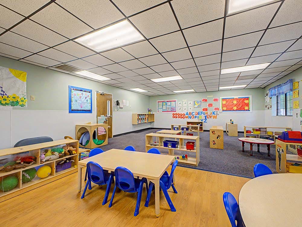 Empty classroom with small tables and chairs