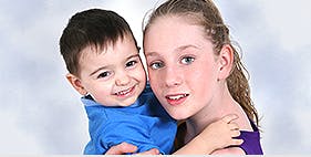 Teen holding a child