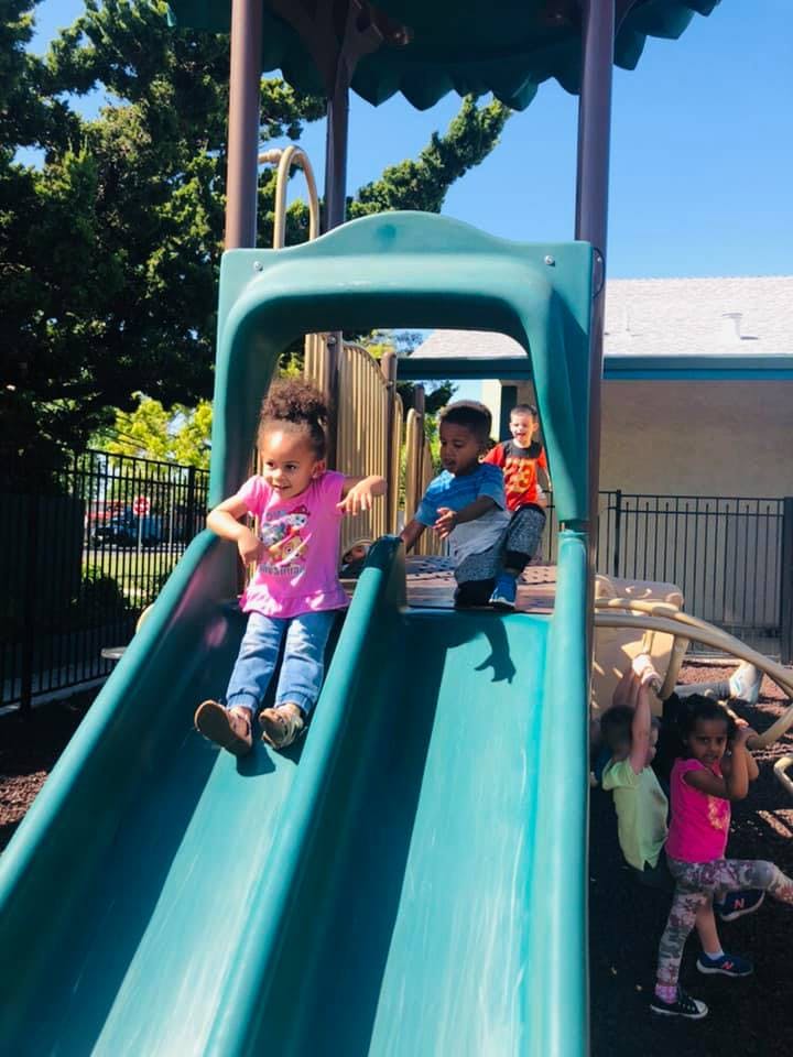 Children playing on a playground slide