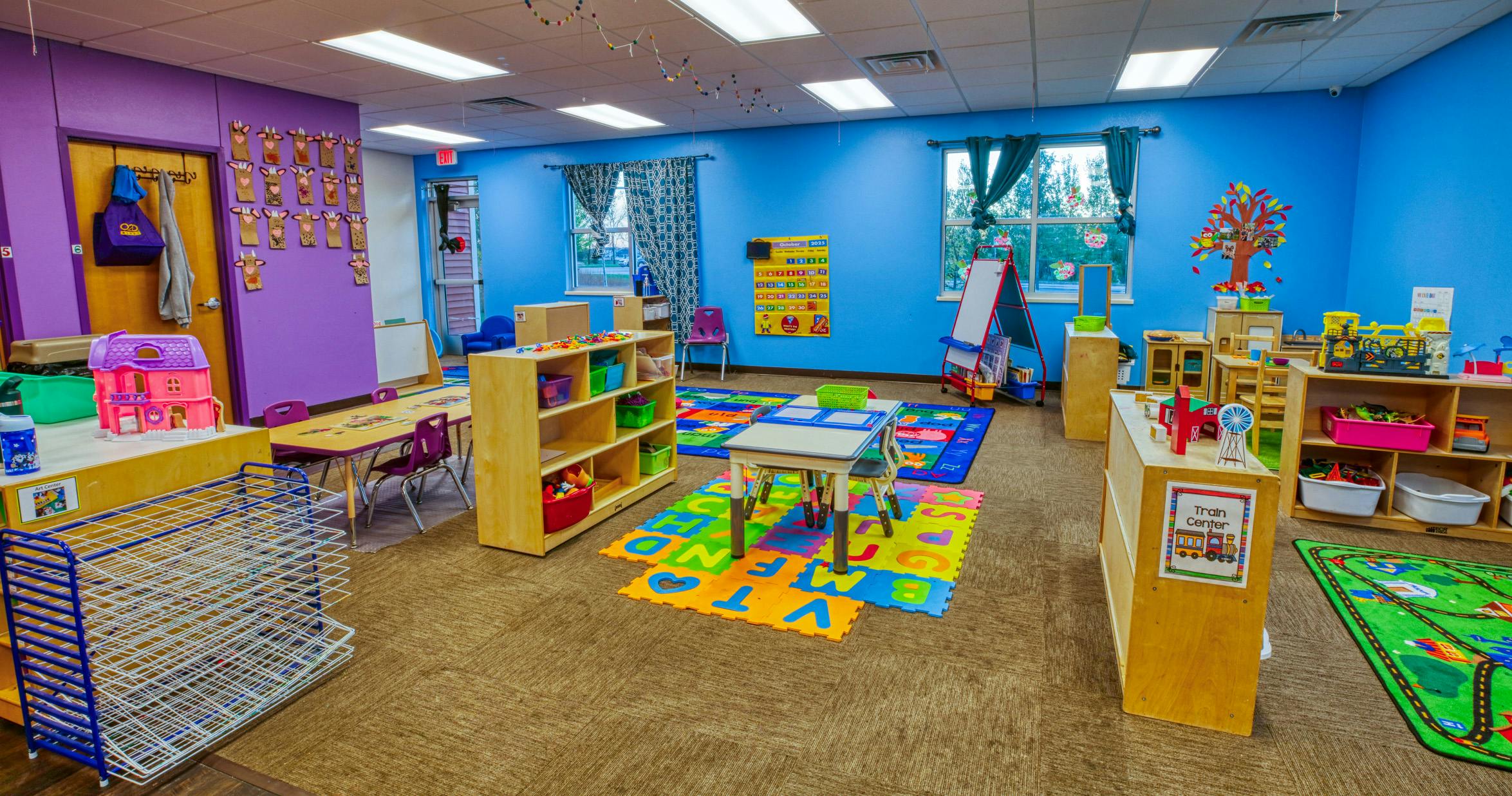 Colorful classroom with various learning stations and play areas