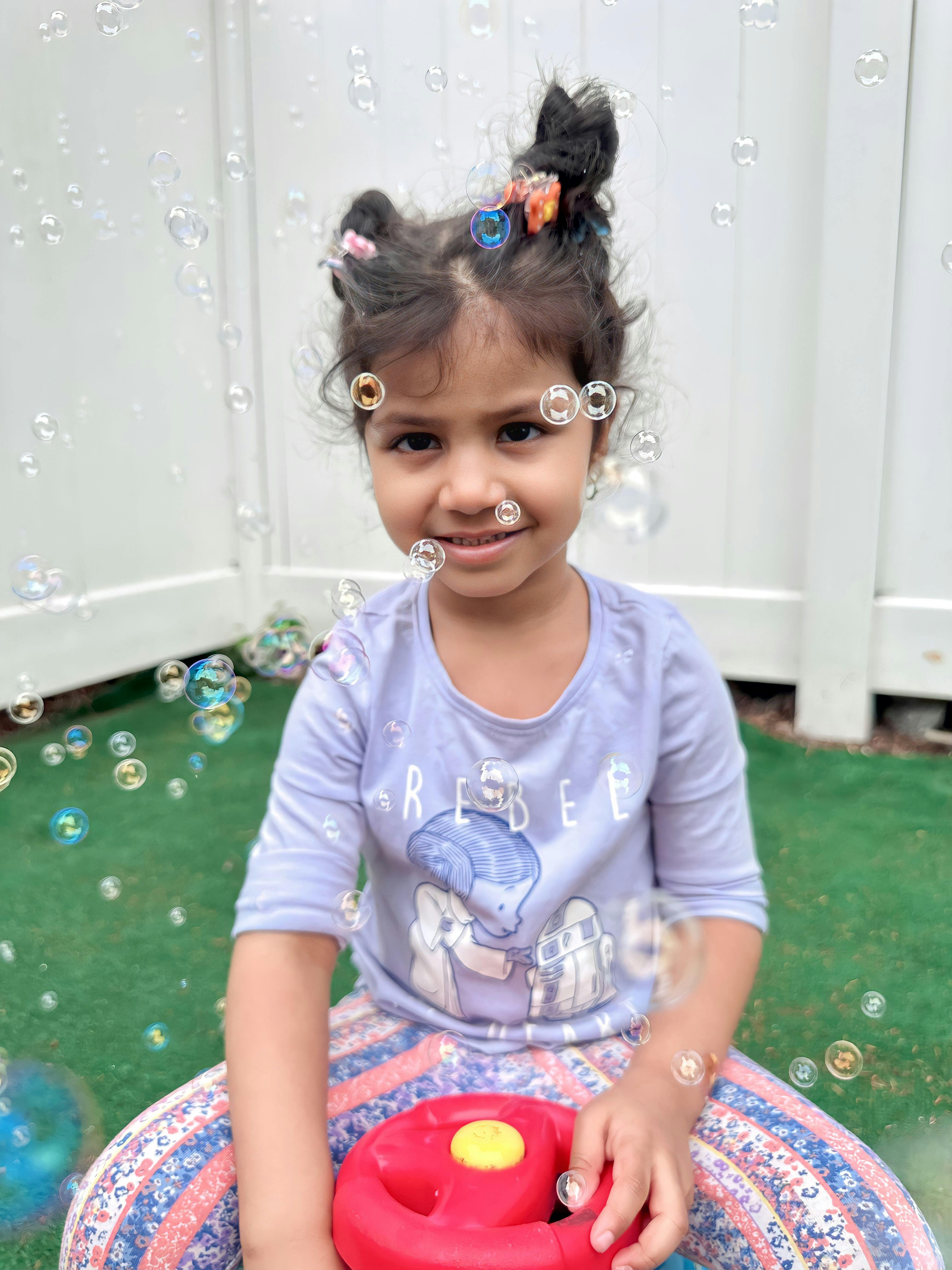 Child with bubbles around their face
