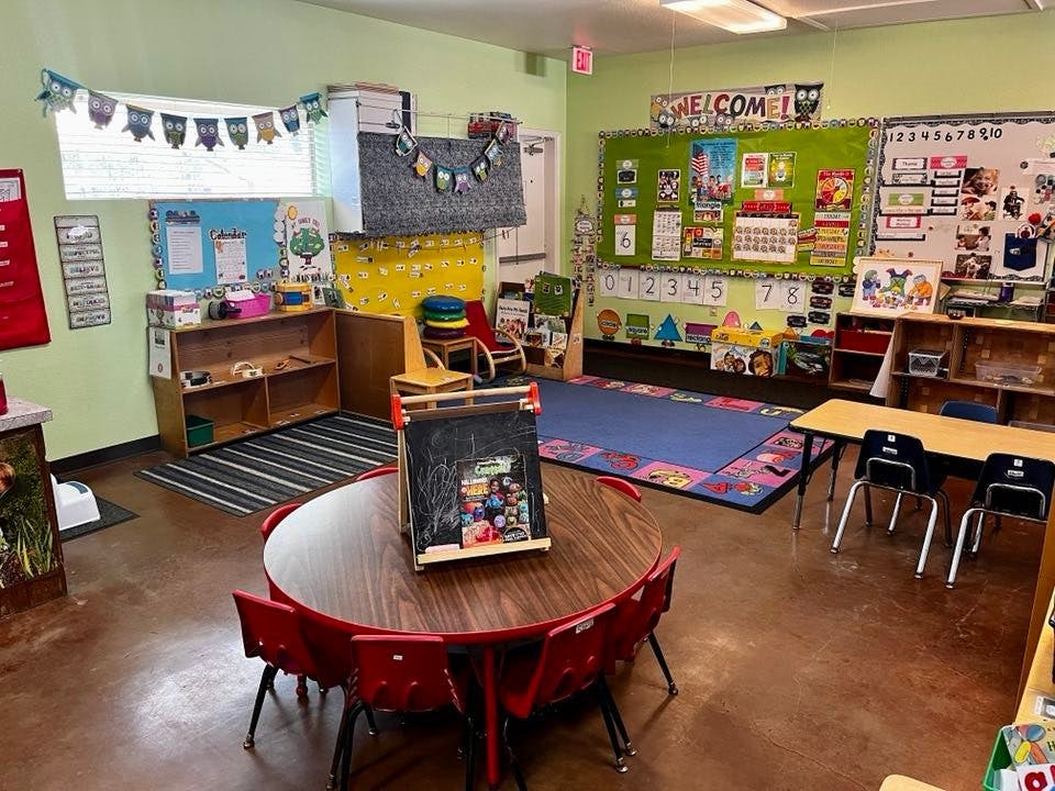 Classroom with tables, chairs, and decorated walls