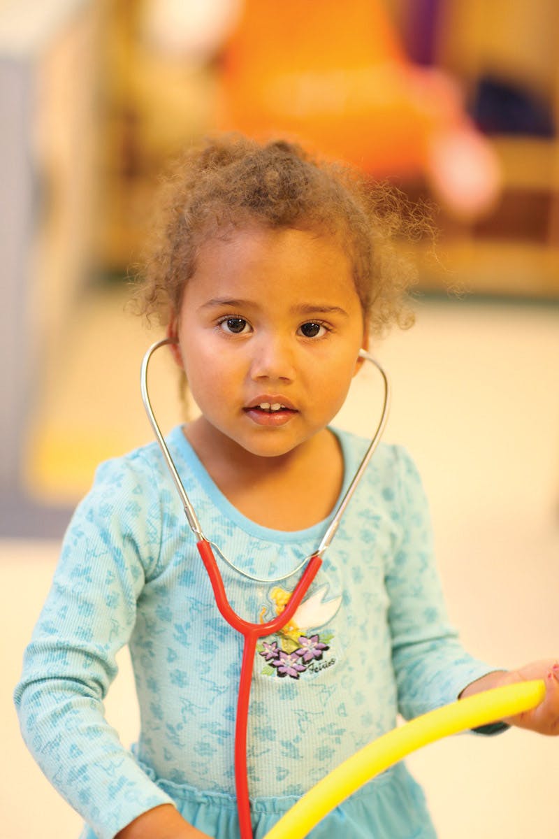 Child wearing a stethoscope