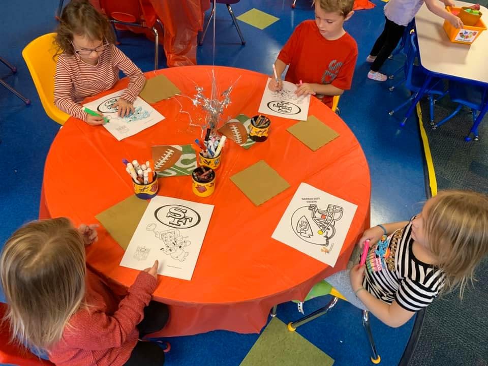 Children coloring at a round table