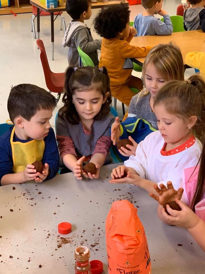 Children making mud pies at a table