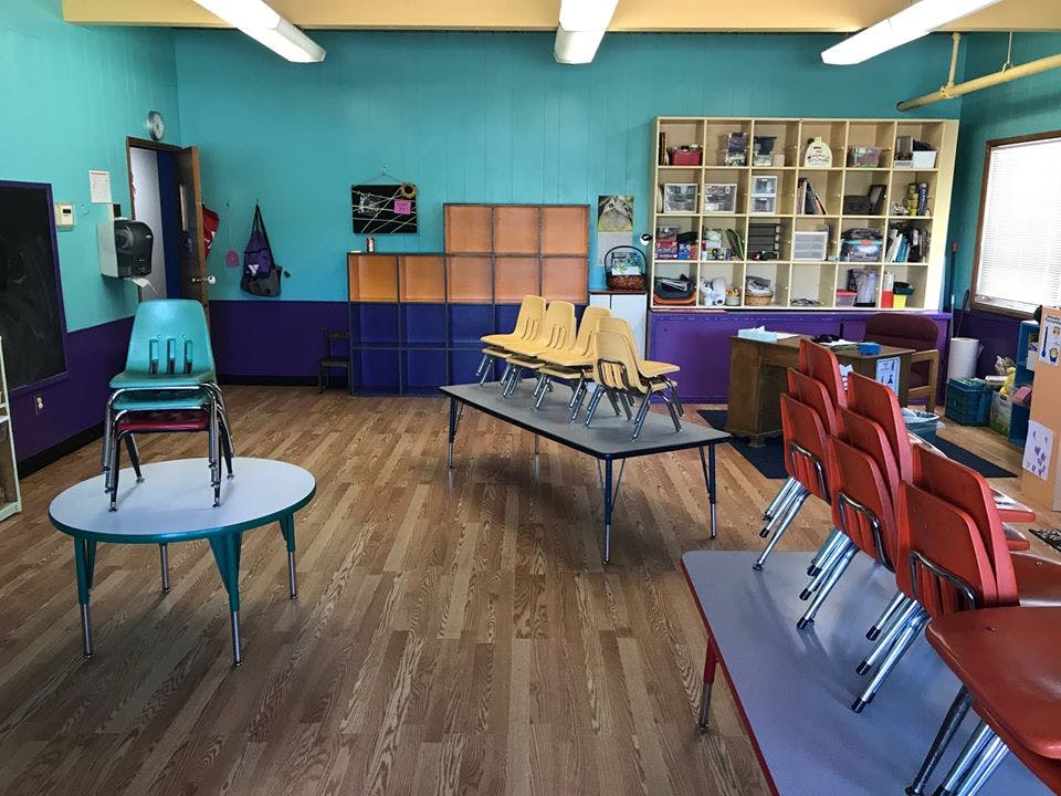 Classroom with stacked chairs on tables