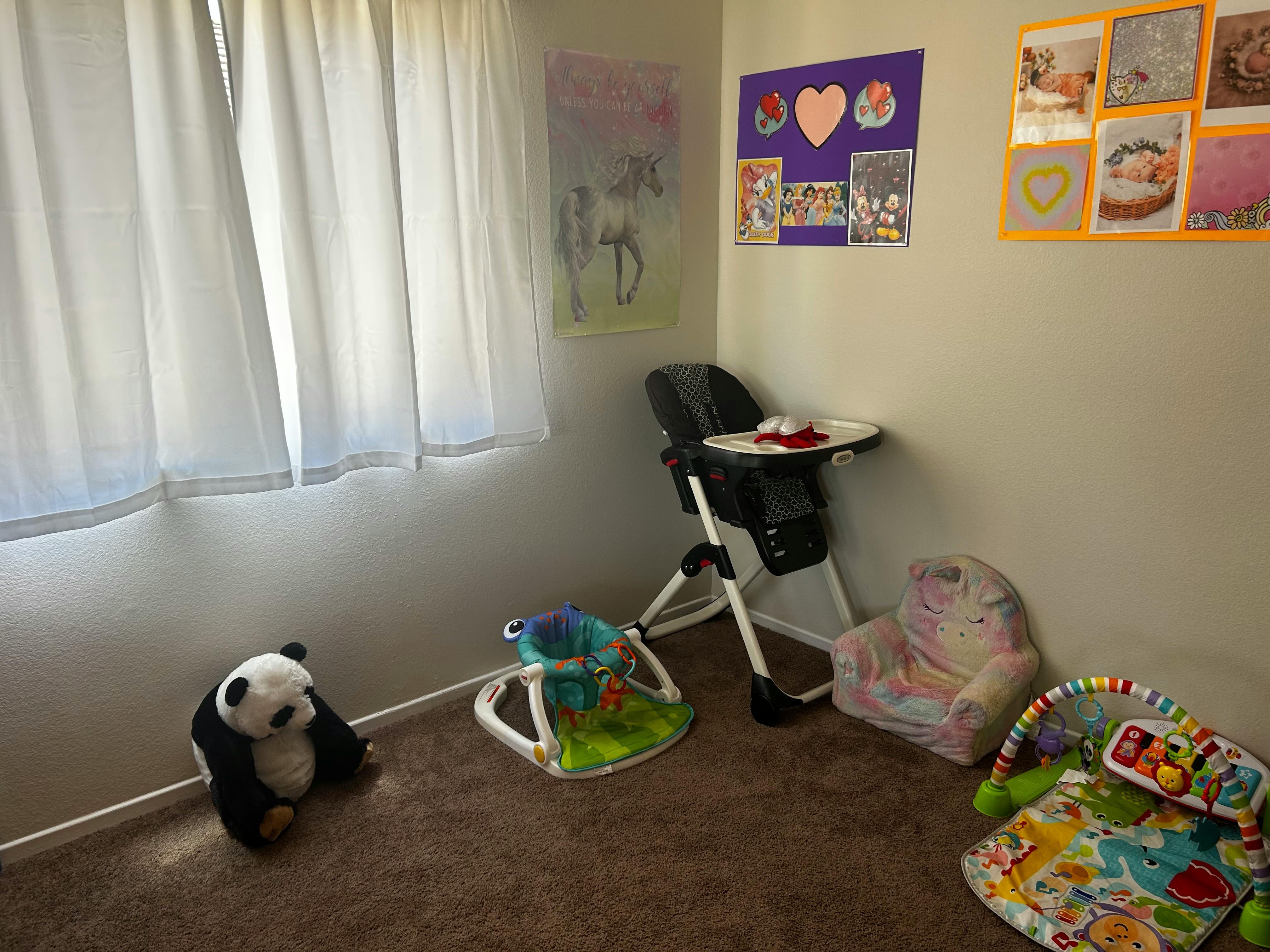 Baby room with high chair, play mat, and stuffed panda