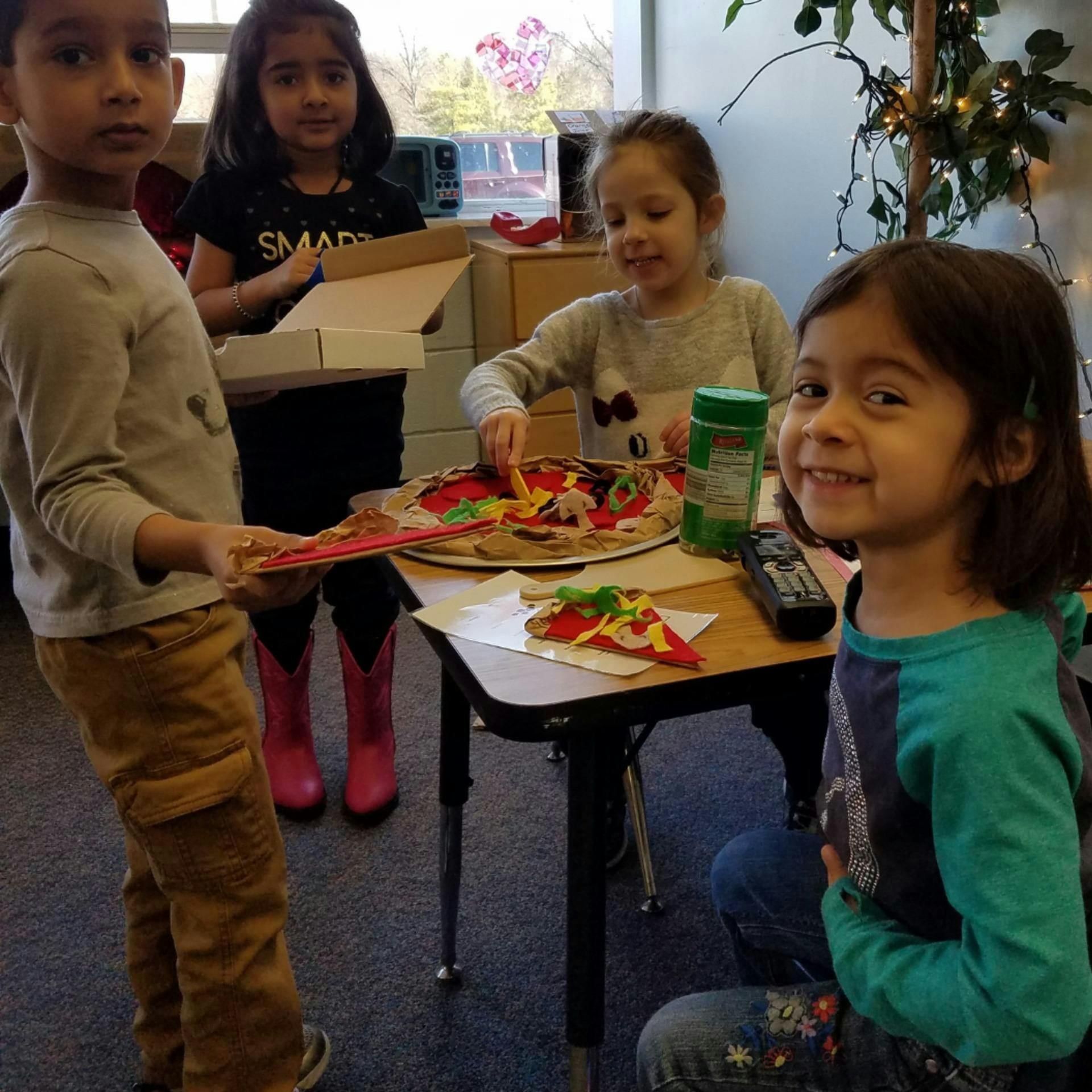 Children playing with toy pizza