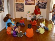 Adults and children sitting on the floor in a circle